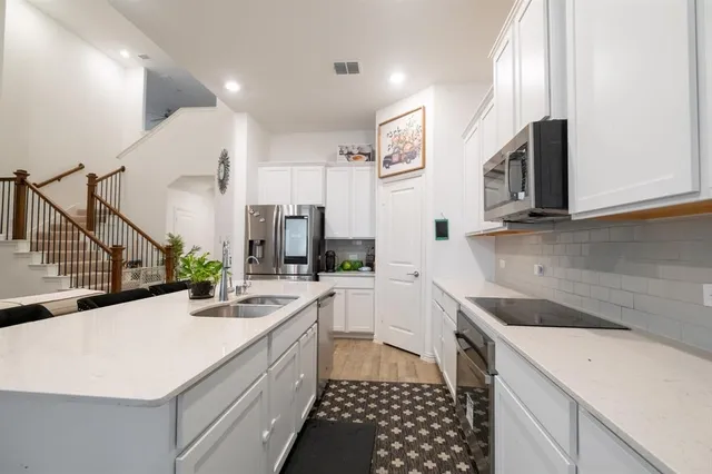 a kitchen with a sink stove and cabinets