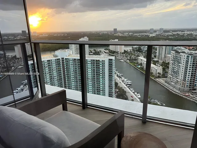a view of a balcony with couches and wooden floor