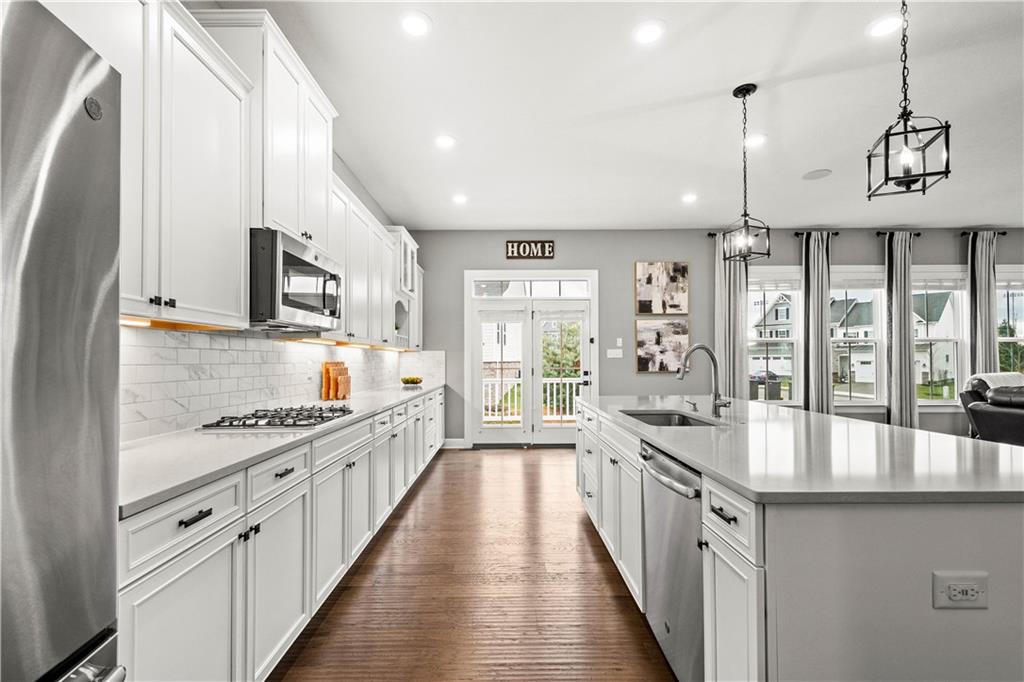 3031 Spruce Road Gibsonia, PA 15044 - Photo 24 of 49 a large kitchen with stainless steel appliances a lot of counter space and a wooden floors