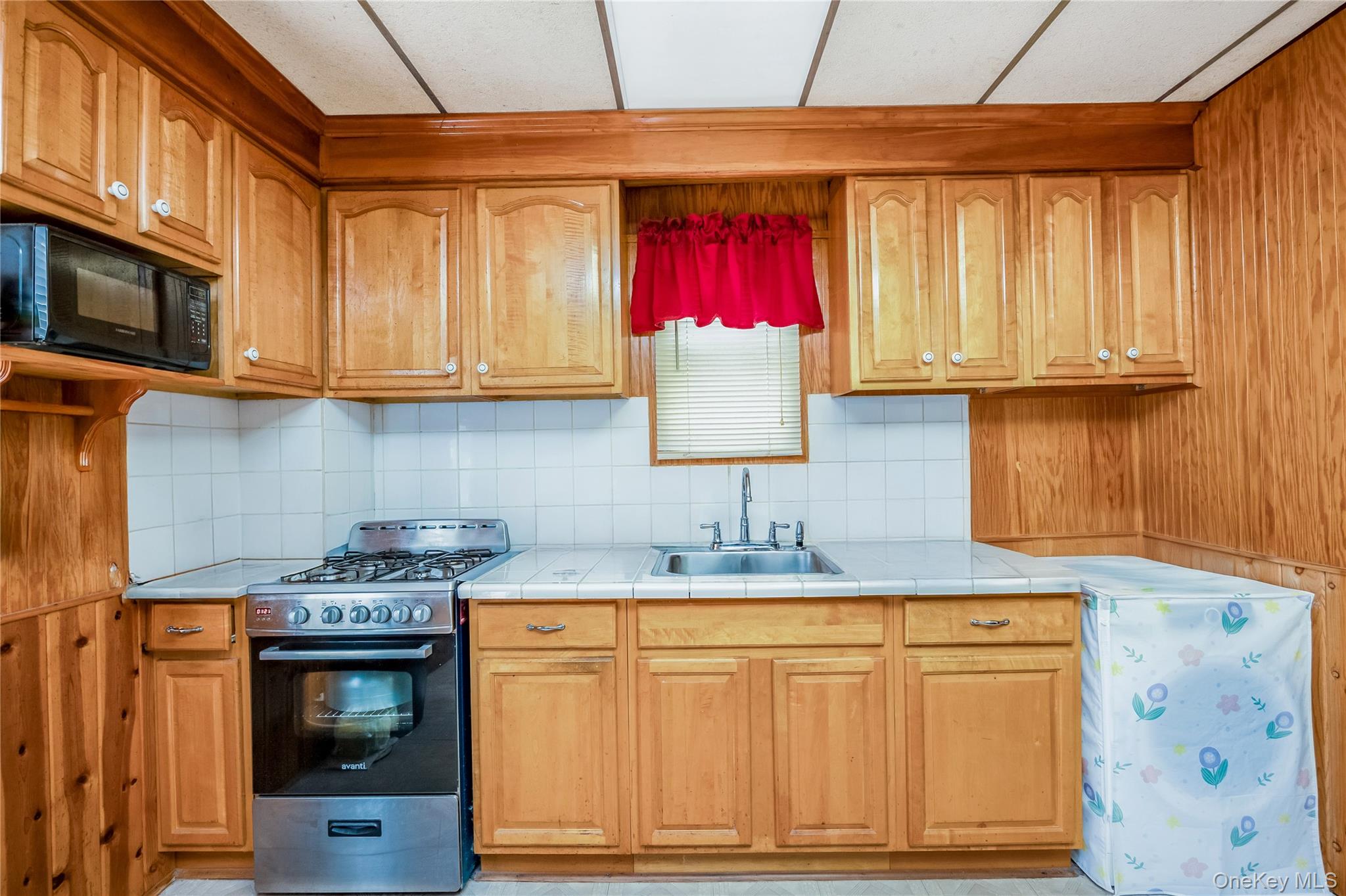 80-50 88th Road Queens, NY 11421 - Photo 11 of 21 a kitchen with stainless steel appliances granite countertop a sink stove and cabinets
