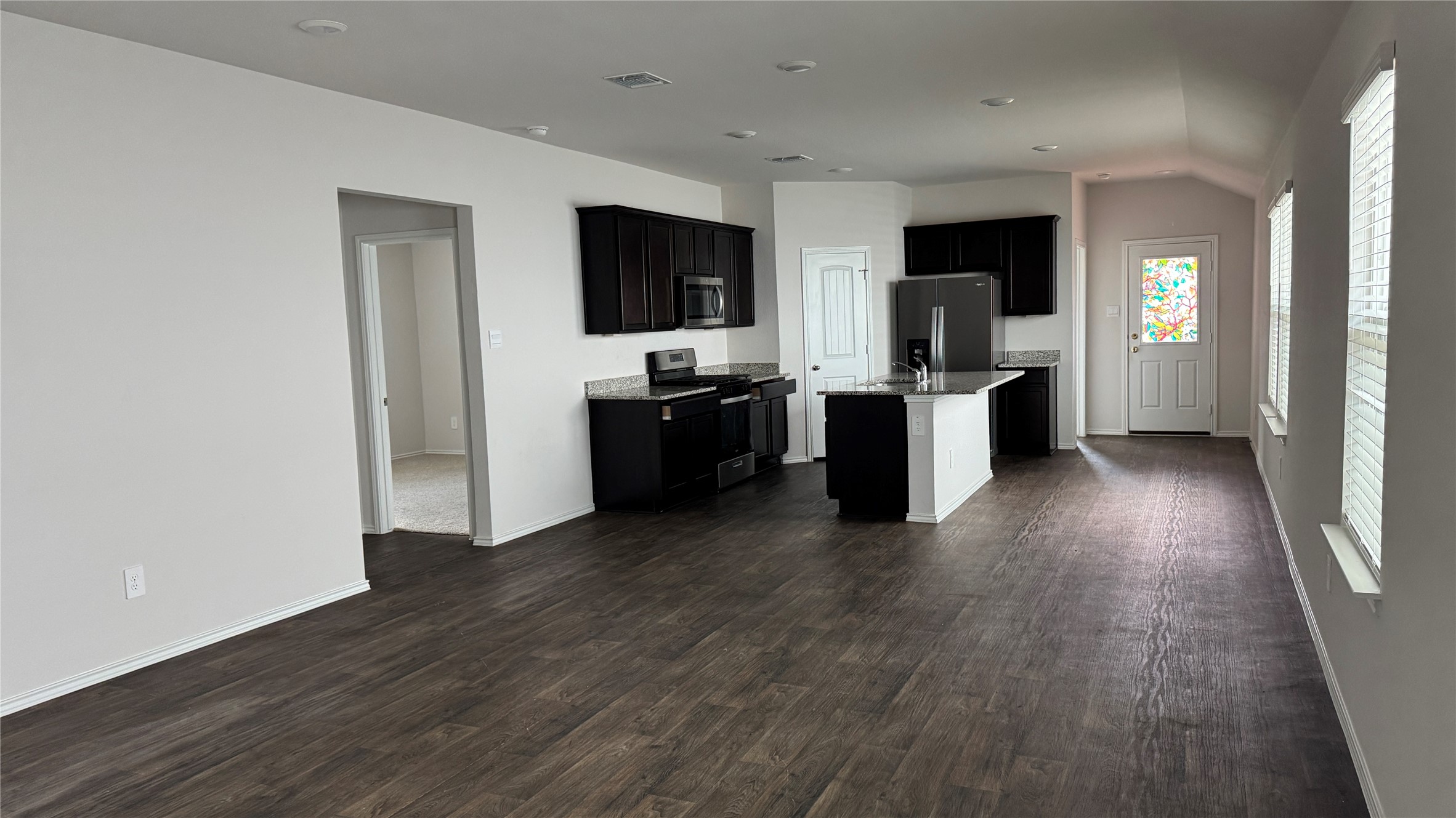 408 Frogmore Loop Kyle, TX 78640 - Photo 6 of 32 An open-concept living area boasts a modern kitchen with a large island and ample space for gatherings.