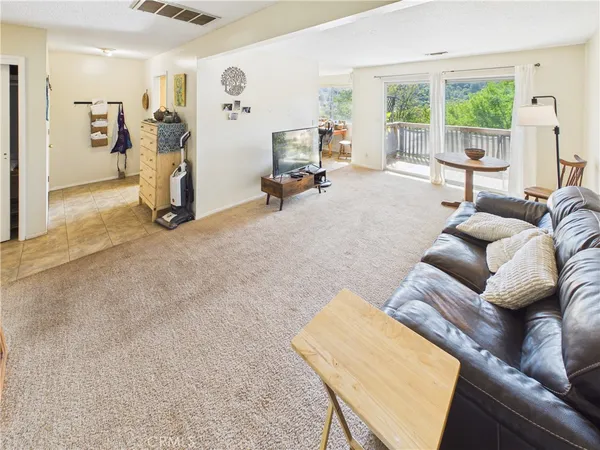 a living room with furniture a large window with outer view