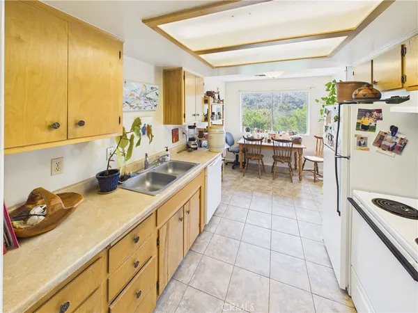 a spacious bathroom with a granite countertop tub a mirror and a potted plant