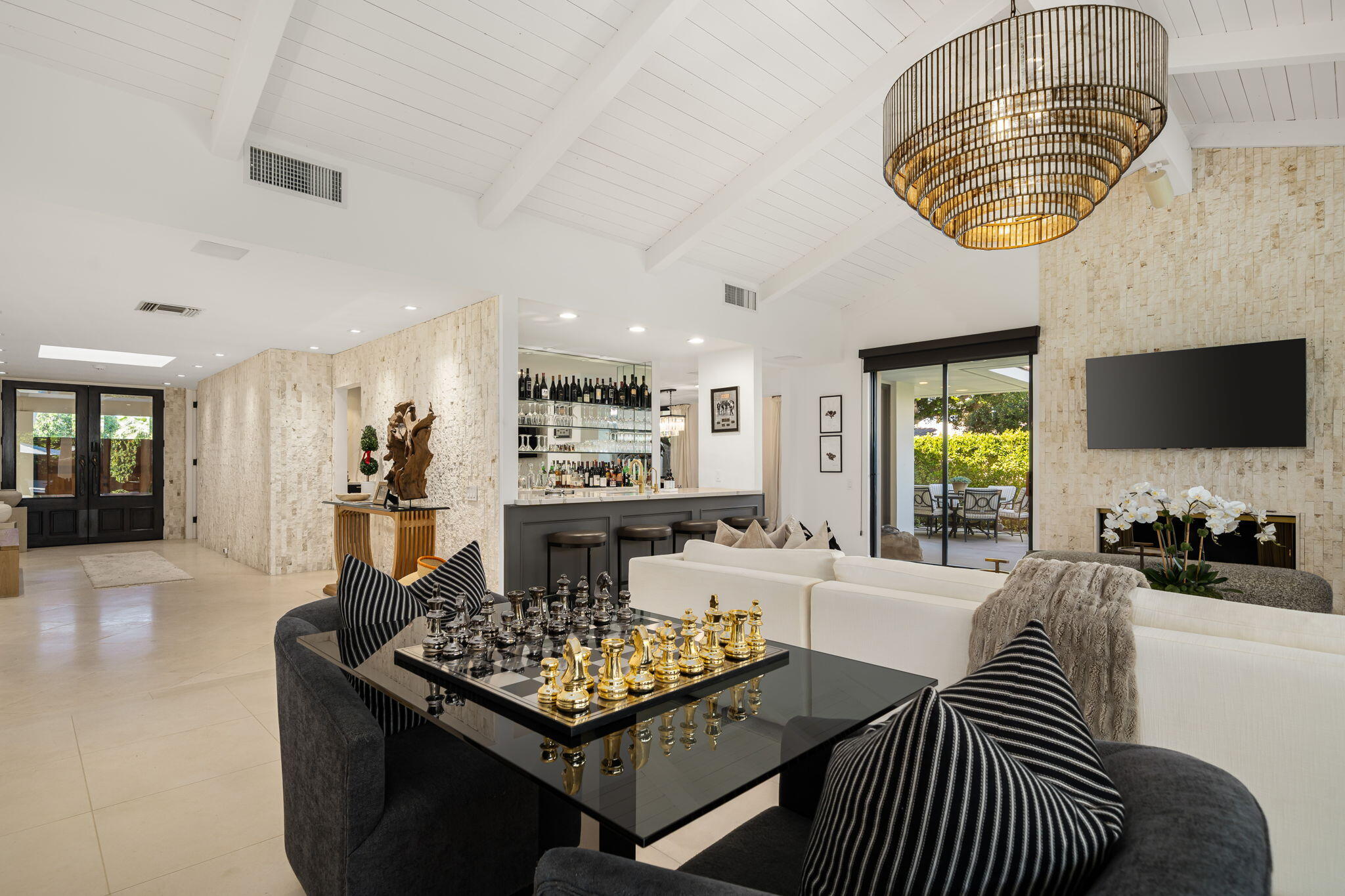 6 Exeter Court Rancho Mirage, CA 92270 - Photo 12 of 54 a living room with furniture a chandelier and a flat screen tv