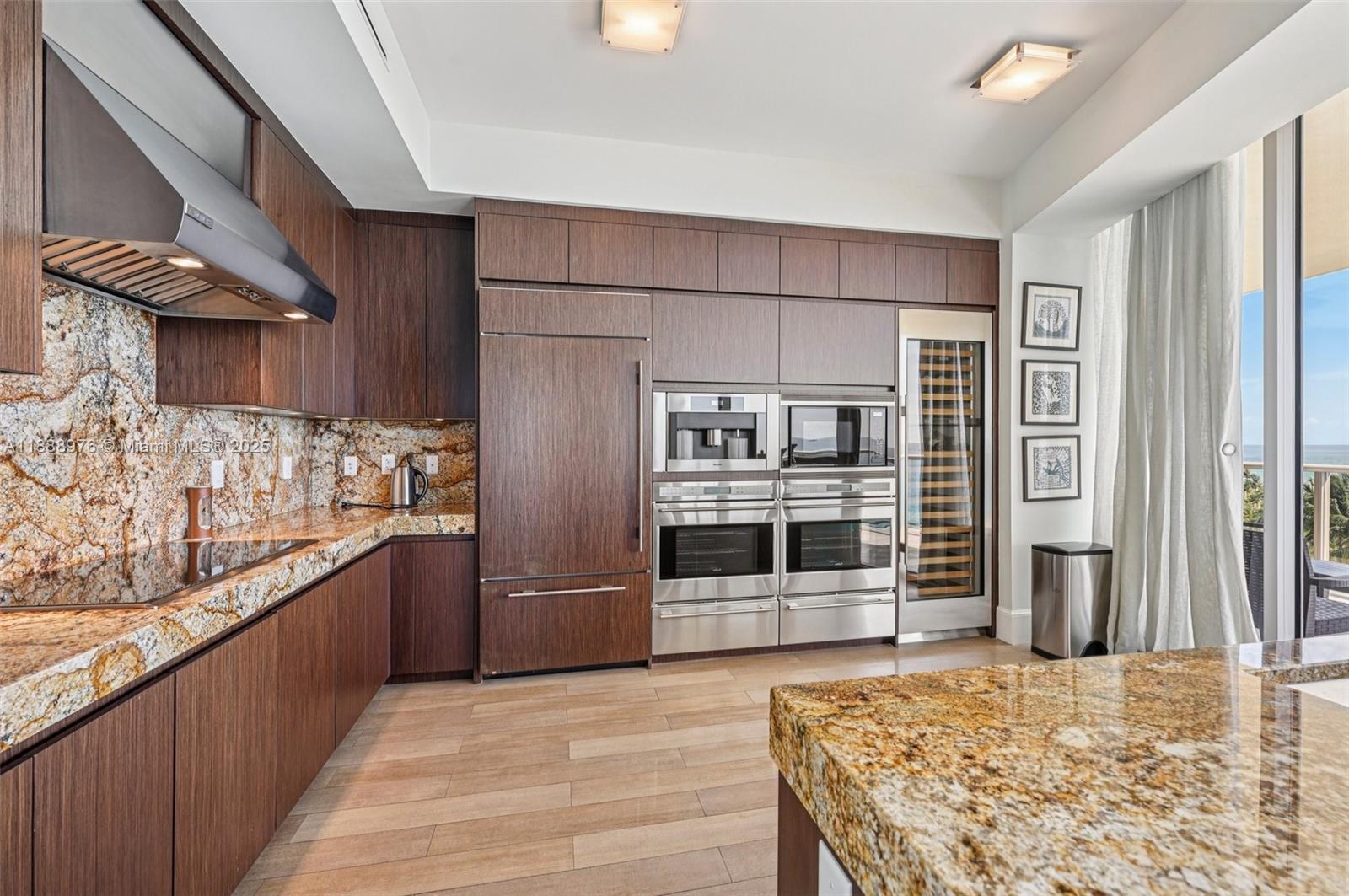 9703 Collins Avenue, Unit 600 Bal Harbour, FL 33154 - Photo 15 of 53 a kitchen with stainless steel appliances granite countertop a refrigerator and a sink