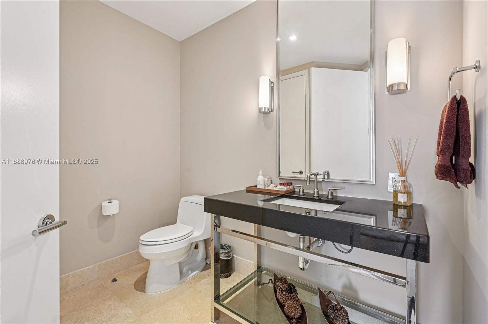 9703 Collins Avenue, Unit 600 Bal Harbour, FL 33154 - Photo 21 of 53 a bathroom with a granite countertop sink a toilet and a mirror