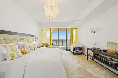 a spacious bedroom with a bed and a large window