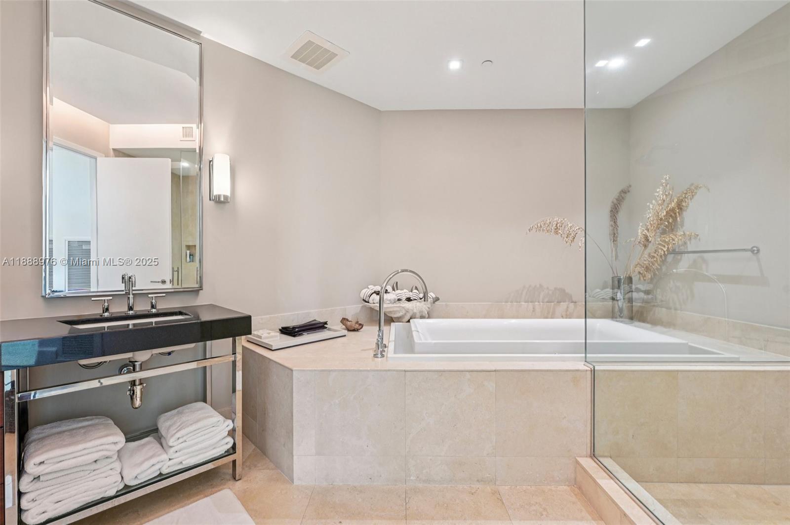 9703 Collins Avenue, Unit 600 Bal Harbour, FL 33154 - Photo 26 of 53 a bathroom with a tub sink and mirror