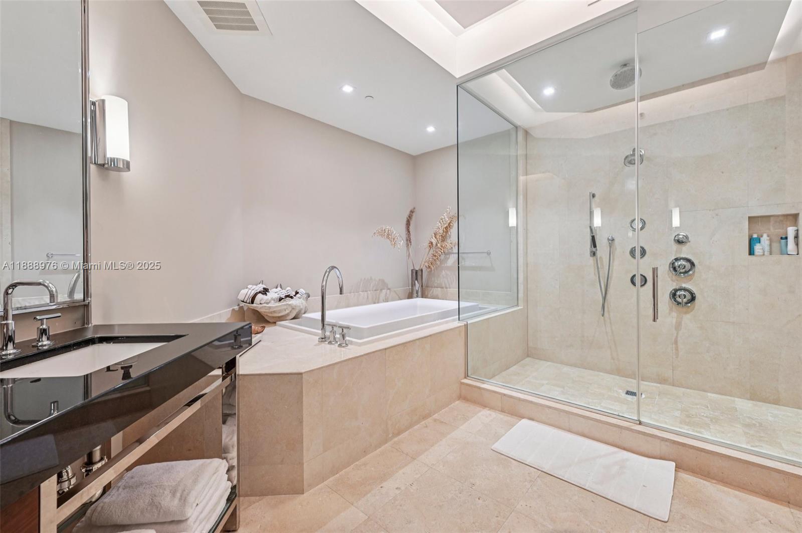 9703 Collins Avenue, Unit 600 Bal Harbour, FL 33154 - Photo 27 of 53 a bathroom with a tub sink shower and mirror