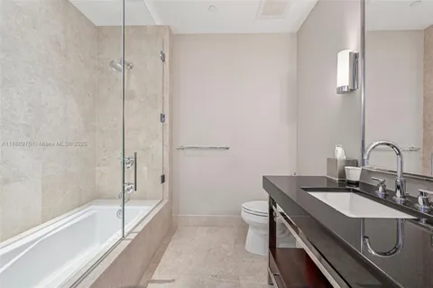 a dining room with furniture and a chandelier