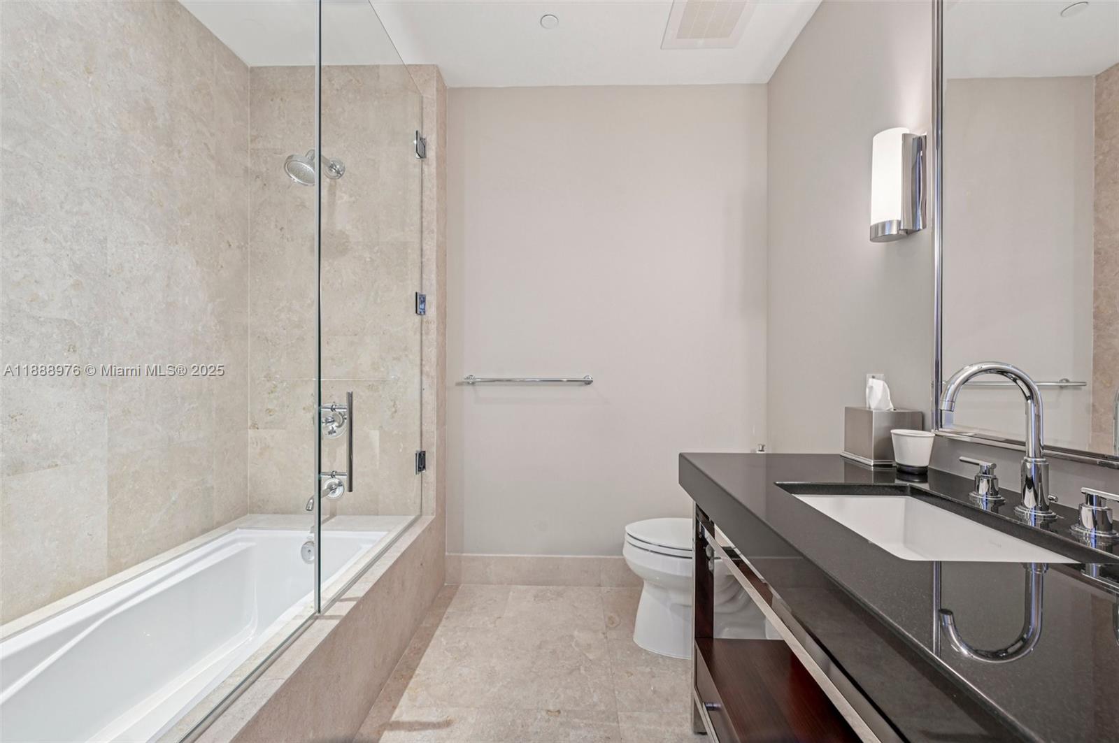 9703 Collins Avenue, Unit 600 Bal Harbour, FL 33154 - Photo 29 of 53 a bathroom with a granite countertop sink a toilet and bathtub