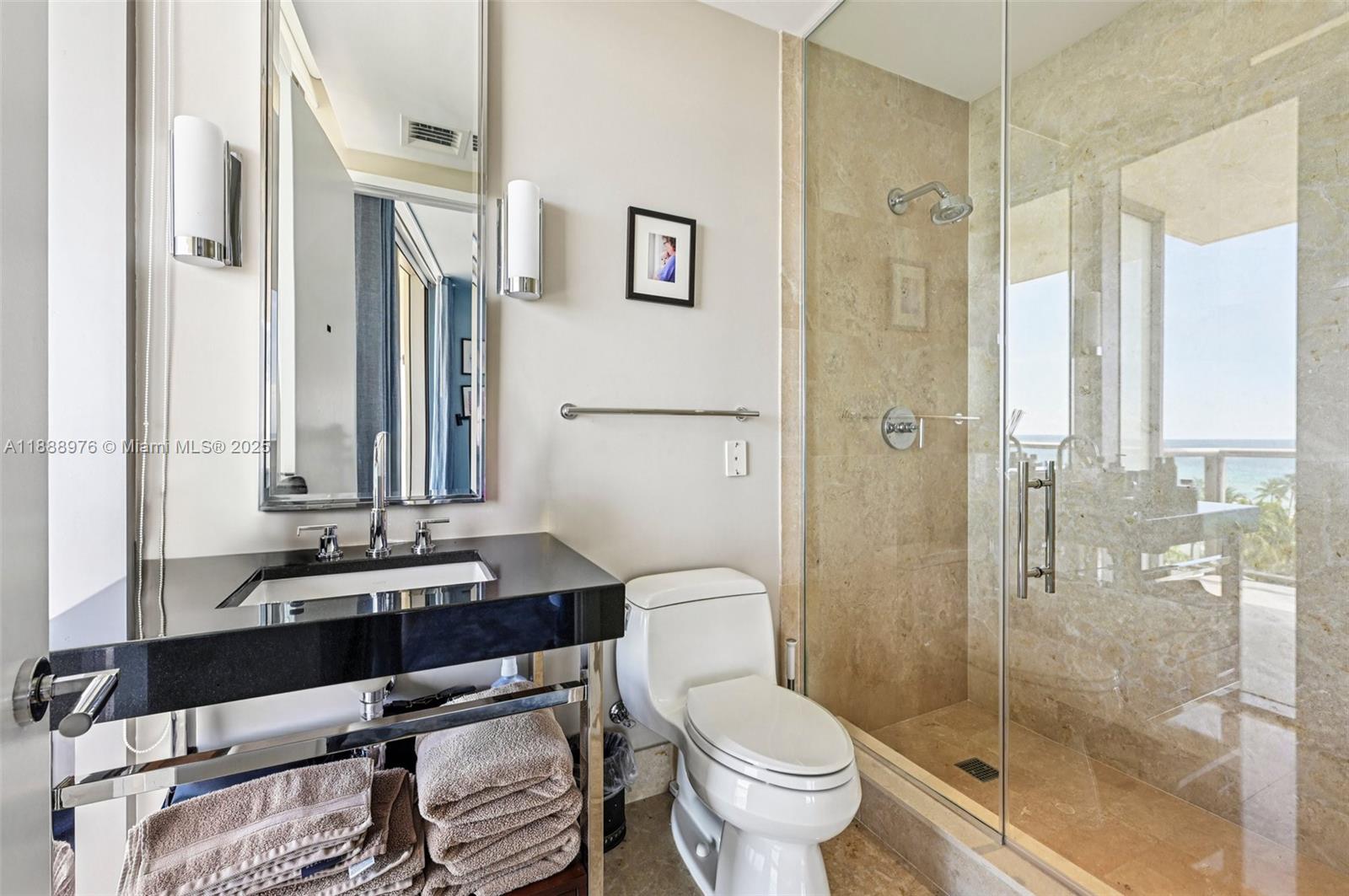 9703 Collins Avenue, Unit 600 Bal Harbour, FL 33154 - Photo 33 of 53 a bathroom with a double vanity sink toilet mirror and shower