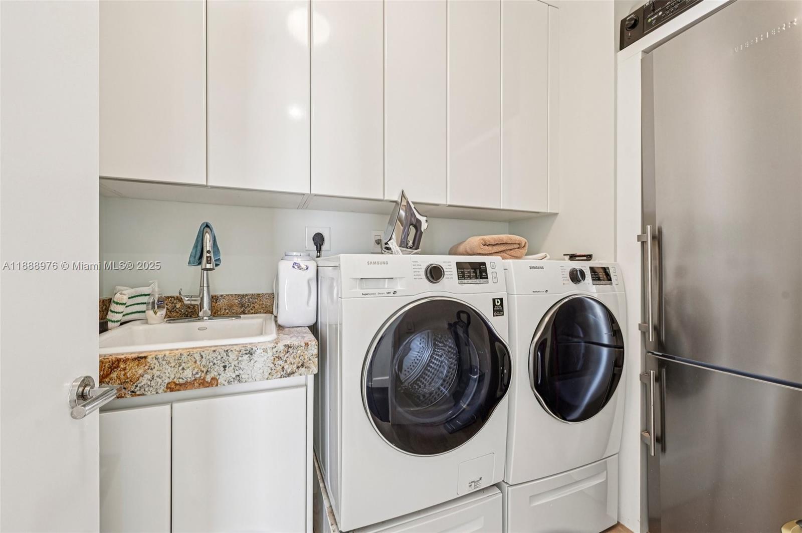 9703 Collins Avenue, Unit 600 Bal Harbour, FL 33154 - Photo 36 of 53 a utility room with dryer and washer