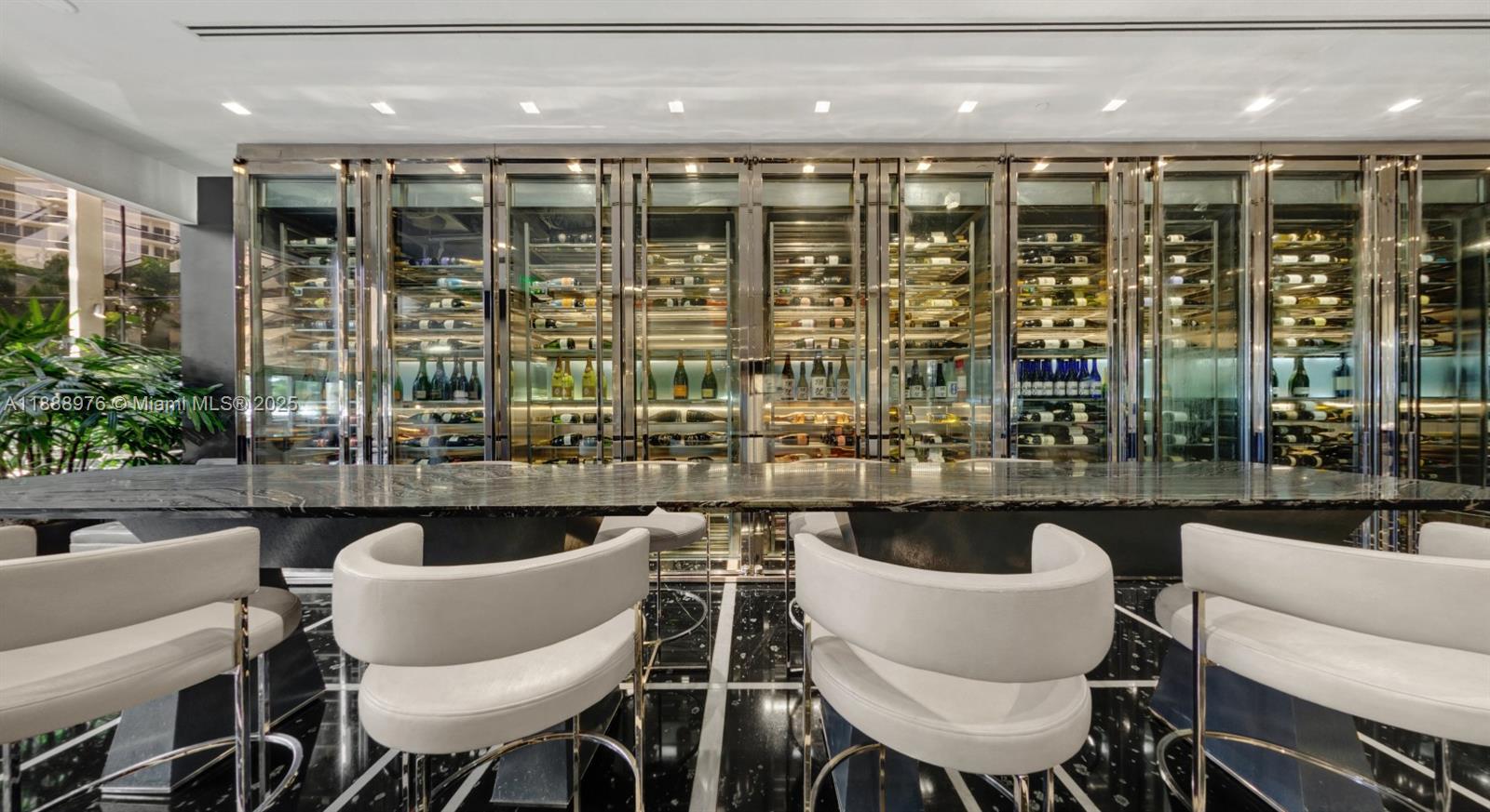 9703 Collins Avenue, Unit 600 Bal Harbour, FL 33154 - Photo 49 of 53 a kitchen with a table chairs sink and cabinets