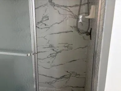 a bathroom with a glass shower door