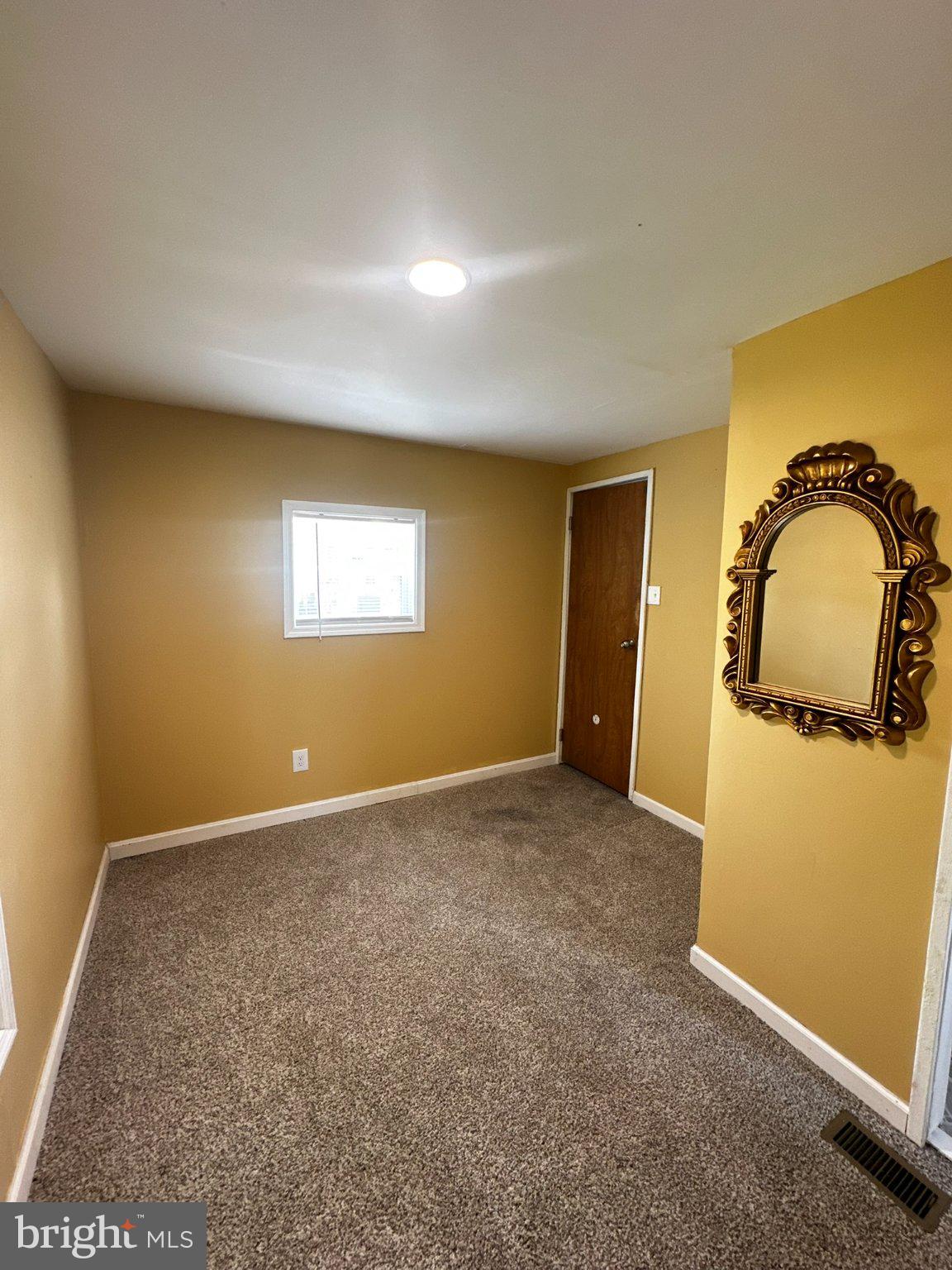 31777 Siham Road Lewes, DE 19958 - Photo 20 of 46 Cozy room with warm golden hues.