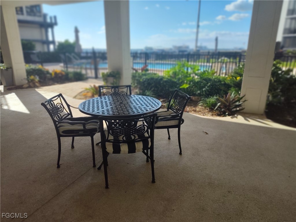 2350 West First Street, Unit 203 Fort Myers, FL 33901 - Photo 11 of 15 a view of a patio with table and chairs and potted plants