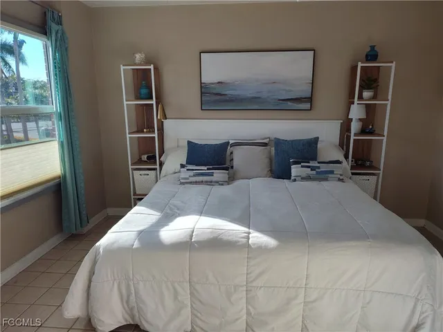 a bathroom with a granite countertop toilet sink and mirror