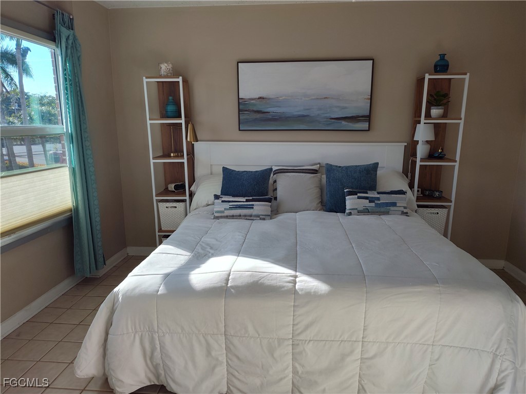 2350 West First Street, Unit 203 Fort Myers, FL 33901 - Photo 6 of 15 a bedroom with a bed and a window