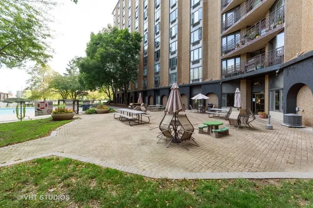 a view of a building with sitting area and furniture