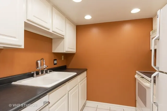 a kitchen with a sink cabinets and a stove top oven