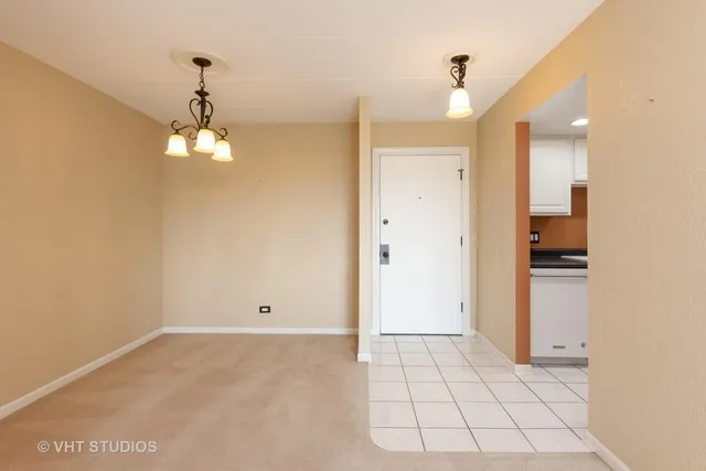 a view of kitchen with granite countertop cabinets and refrigerator
