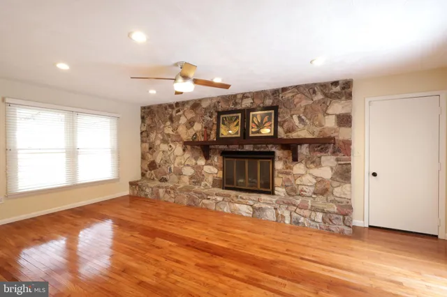 a view of a livingroom with a hardwood floor and a ceiling fan