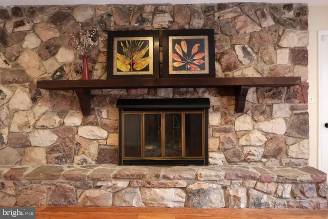 a view of a kitchen with kitchen island stainless steel appliances wooden floor and a large window
