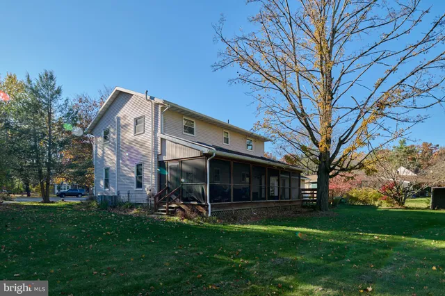 a view of a house with a large tree