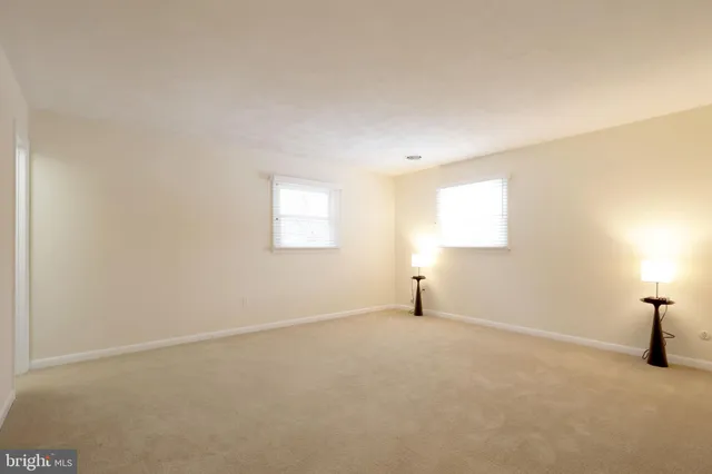 a bathroom with a granite countertop sink toilet and a mirror