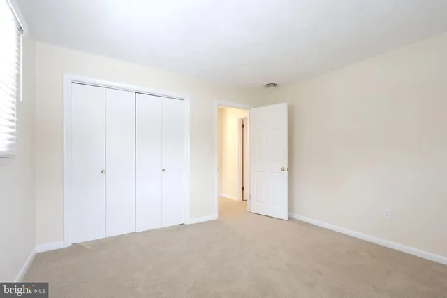 a view of an empty room and a window