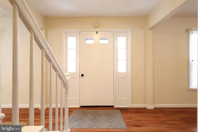 a view of entryway with wooden floor and stairs