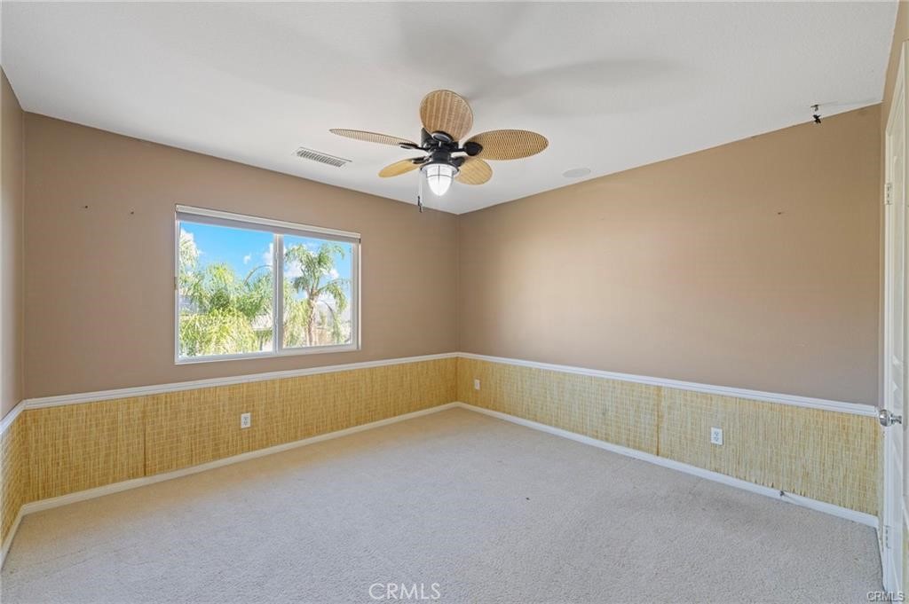 8634 Hunt Canyon Road Corona, CA 92883 - Photo 22 of 31 an empty room with windows and ceiling fan