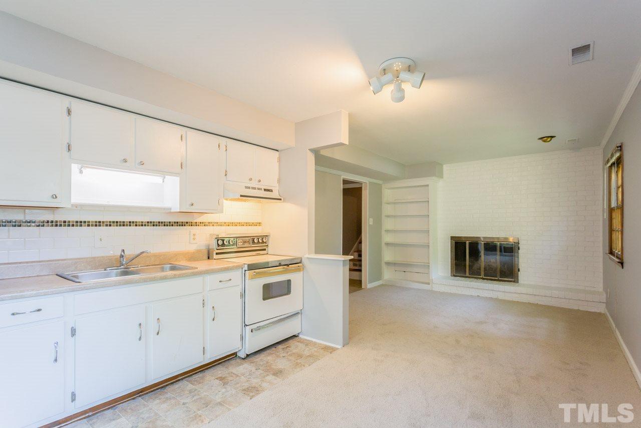 1547 Fountain Ridge Road Chapel Hill, NC 27517 - Photo 13 of 22 a kitchen with granite countertop white cabinets and white appliances