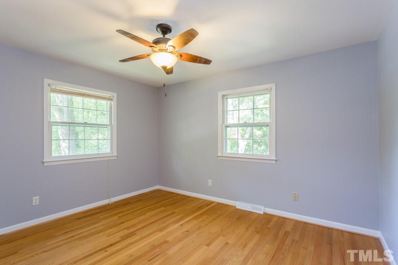 1547 Fountain Ridge Road Chapel Hill, NC 27517 - Photo 16 of 22 a view of an empty room with chandelier fan and a window