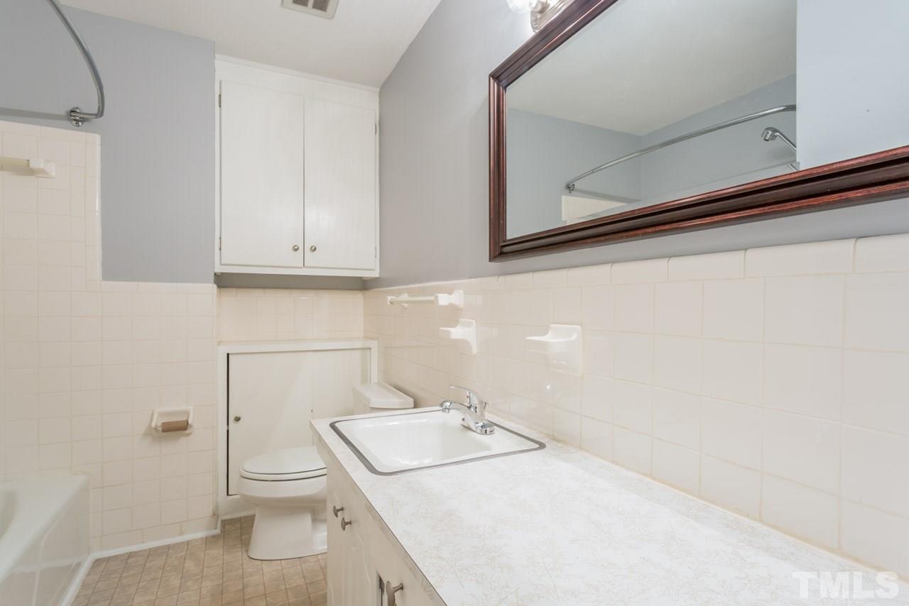 1547 Fountain Ridge Road Chapel Hill, NC 27517 - Photo 17 of 22 a bathroom with a sink a toilet and vanity