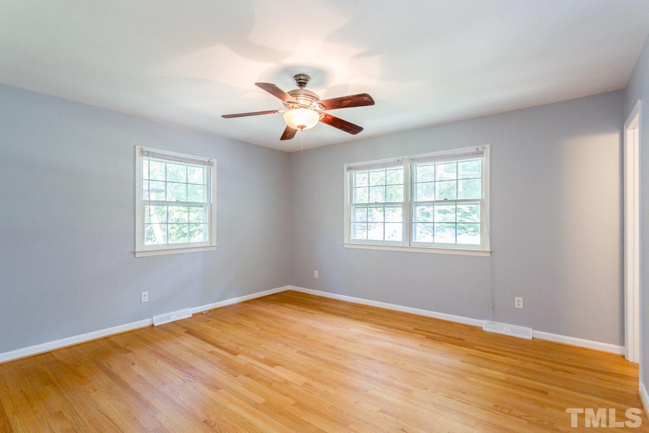 1547 Fountain Ridge Road Chapel Hill, NC 27517 - Photo 18 of 22 a view of an empty room with chandelier fan and a window