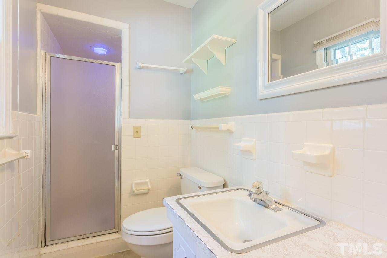 1547 Fountain Ridge Road Chapel Hill, NC 27517 - Photo 19 of 22 a bathroom with a sink a toilet and a mirror