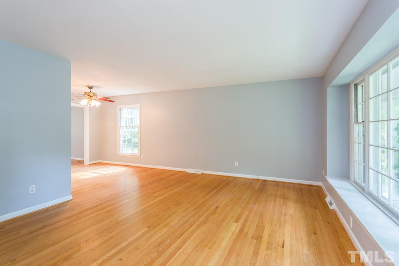 1547 Fountain Ridge Road Chapel Hill, NC 27517 - Photo 3 of 22 wooden floor in an empty room with a window