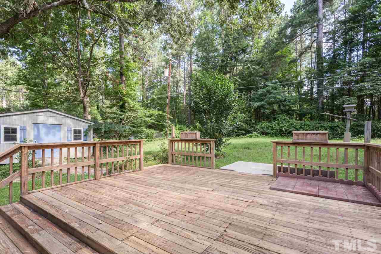 1547 Fountain Ridge Road Chapel Hill, NC 27517 - Photo 21 of 22 a view of a deck with a large trees and wooden fence