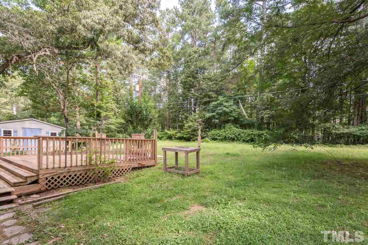 1547 Fountain Ridge Road Chapel Hill, NC 27517 - Photo 22 of 22 a view of a garden with a bench