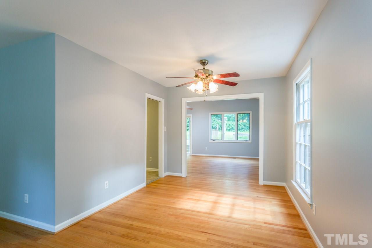 1547 Fountain Ridge Road Chapel Hill, NC 27517 - Photo 4 of 22 a view of an empty room with window and wooden floor