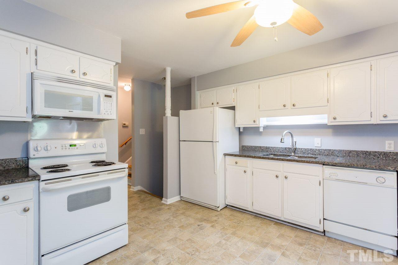 1547 Fountain Ridge Road Chapel Hill, NC 27517 - Photo 7 of 22 a kitchen with granite countertop white cabinets and white appliances