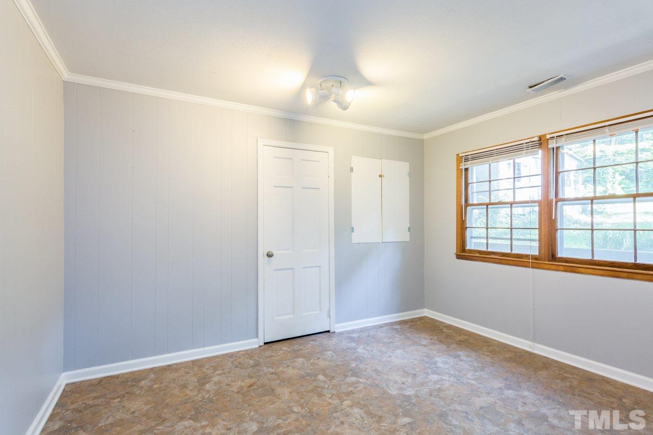1547 Fountain Ridge Road Chapel Hill, NC 27517 - Photo 9 of 22 an empty room with a empty space and windows