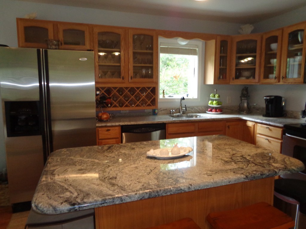 5 Cooper Road Sturbridge, MA 01566 - Photo 12 of 28 a kitchen with kitchen island granite countertop a sink and a refrigerator