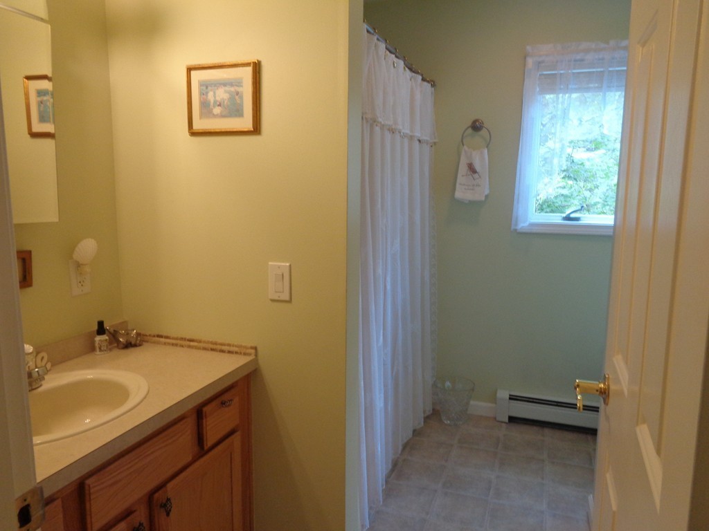5 Cooper Road Sturbridge, MA 01566 - Photo 15 of 28 a bathroom with a sink and a mirror