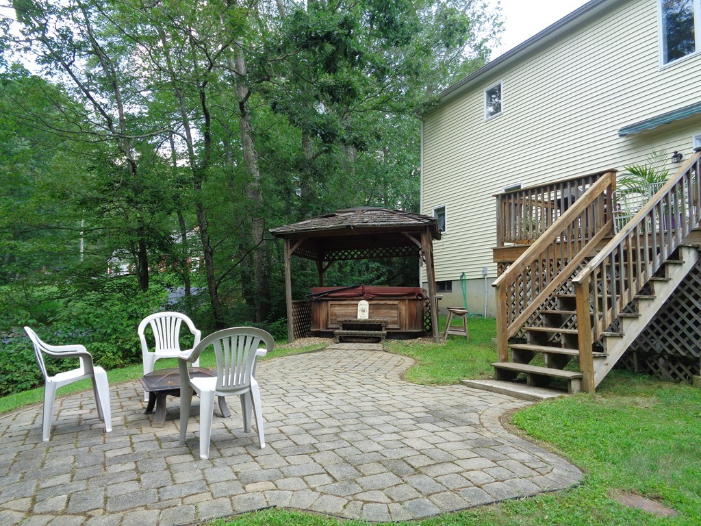 5 Cooper Road Sturbridge, MA 01566 - Photo 5 of 28 a view of a chairs and table in backyard of the house