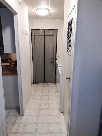 a view of kitchen with cabinets