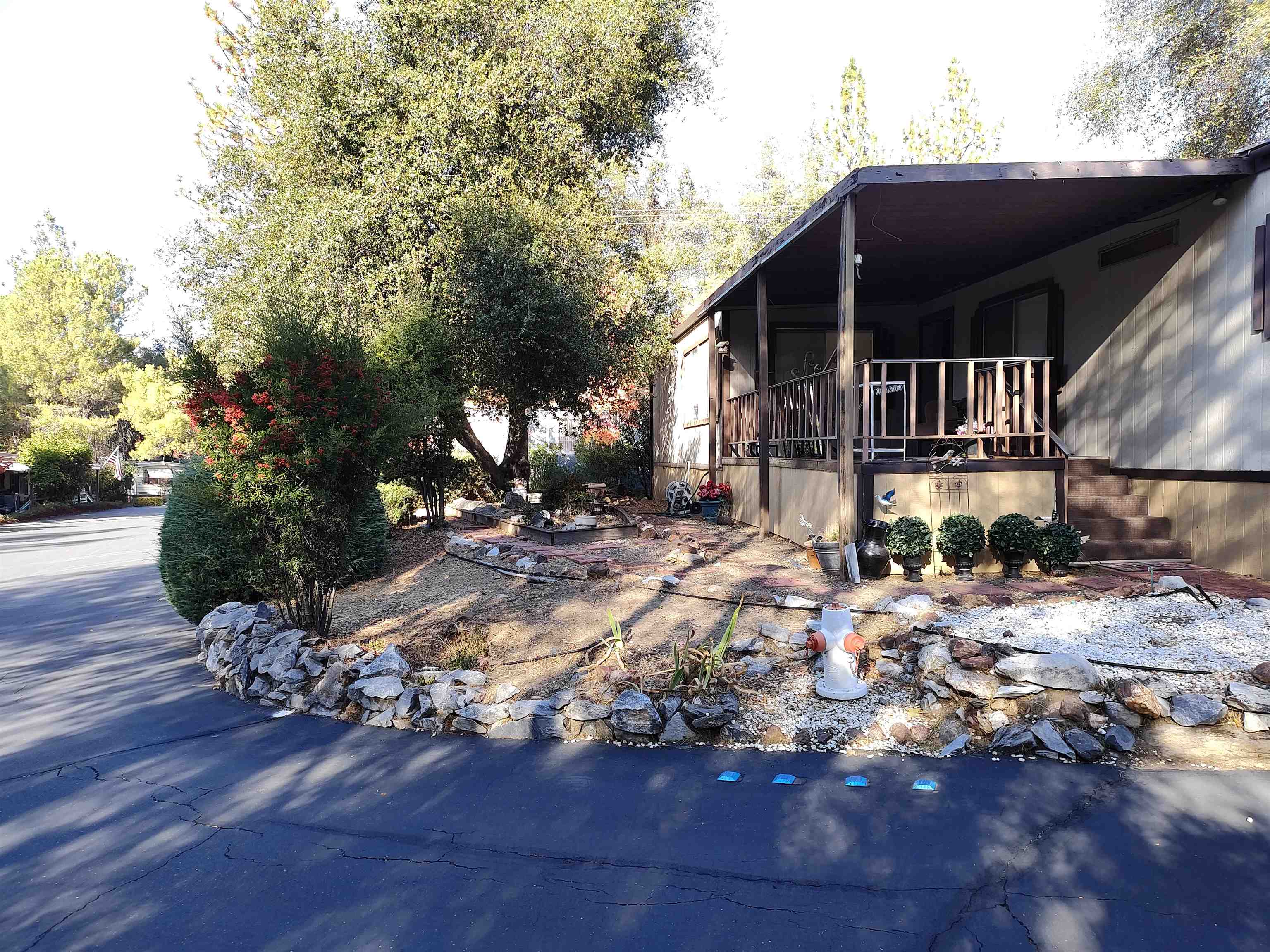10956 Green Street, Unit 152 Columbia, CA 95310 - Photo 3 of 46 a front view of a house with yard