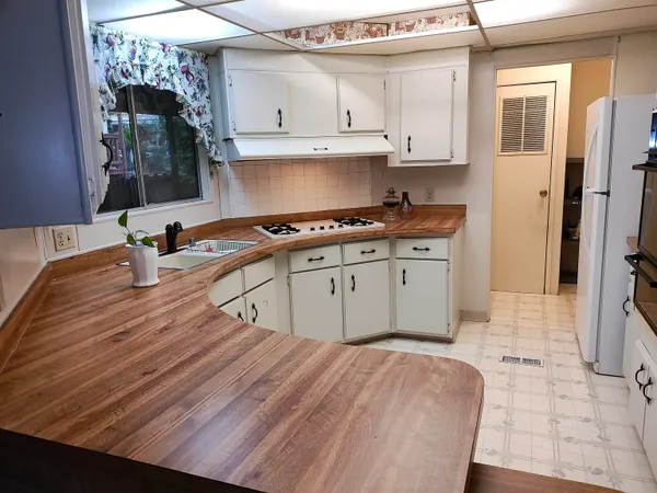 a kitchen with a sink a stove and cabinets